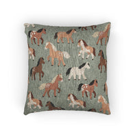 Woven pillow with chestnut, rust and cream horses on sage green, front view