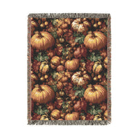 Pumpkin Harvest woven throw blanket with a dense pattern of pumpkins, gourds, acorns and leaves, front view