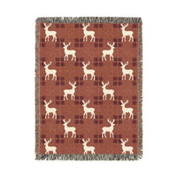Reindeer plaid woven blanket featuring cream reindeer silhouettes on a rust buffalo-check pattern
