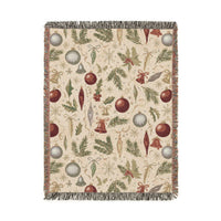 Vintage Christmas woven blanket with glass baubles, brass bells, holly and pine on cream
