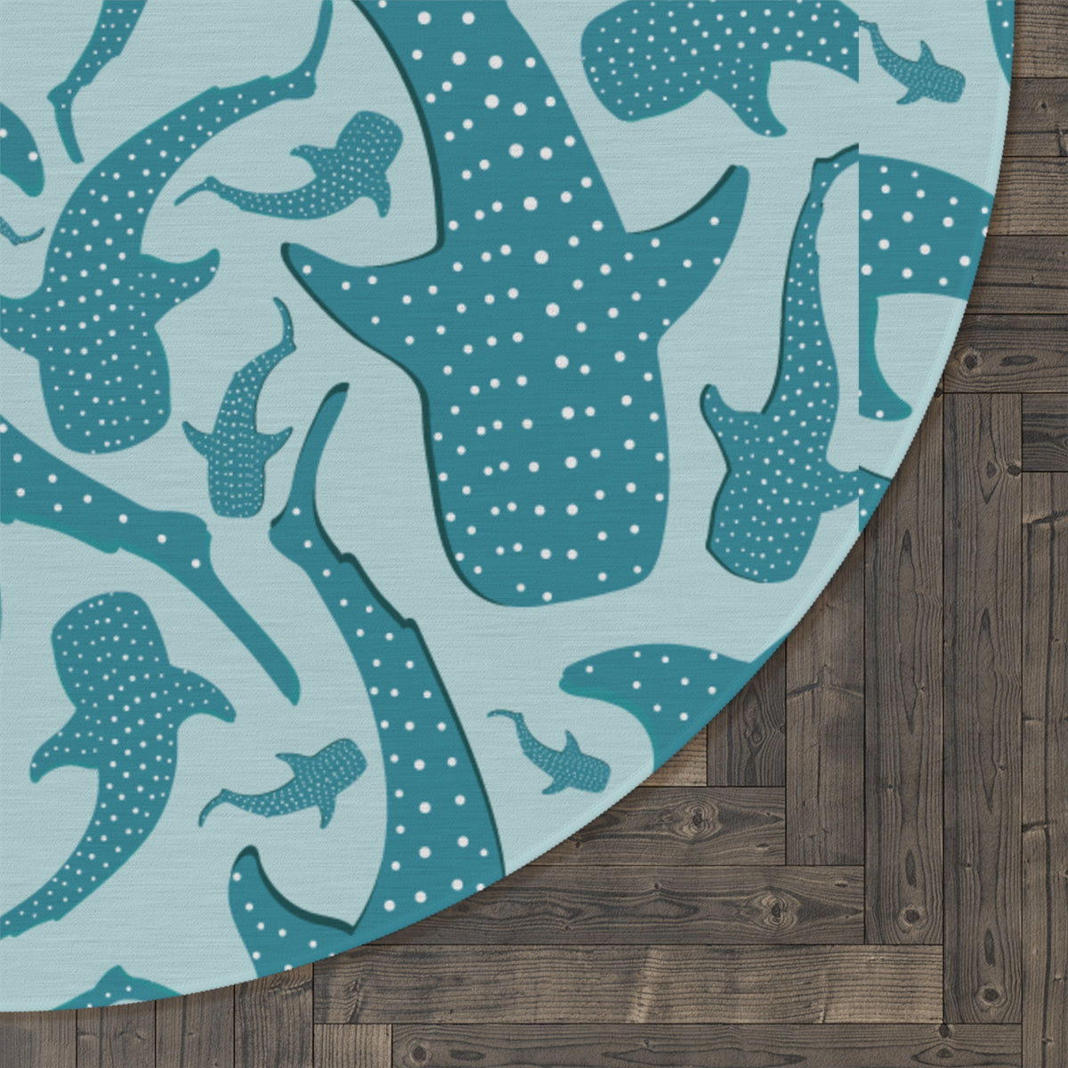 Close-up of the Whale Shark round rug edge against a dark wood floor