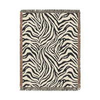 Zebra woven blanket in black and cream with a zebra stripe pattern, shown flat