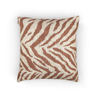 Woven pillow with rust and terracotta zebra stripes on a textured cream ground, front view