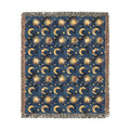 Blanket with celestial pattern of suns, moons, and stars on a blue background