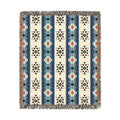 Patterned blanket with blue, beige, and brown colors on a white background
