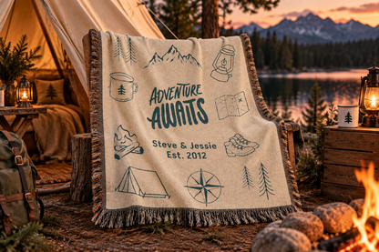 Adventure Awaits personalized woven blanket at a lakeside campsite with a tent at sunset