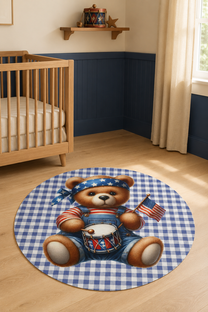 Americana teddy bear round rug on a wooden floor beside a crib