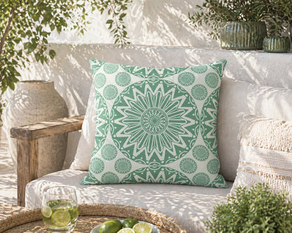 Green Boho Mandala outdoor pillow on a garden bench in dappled sunlight