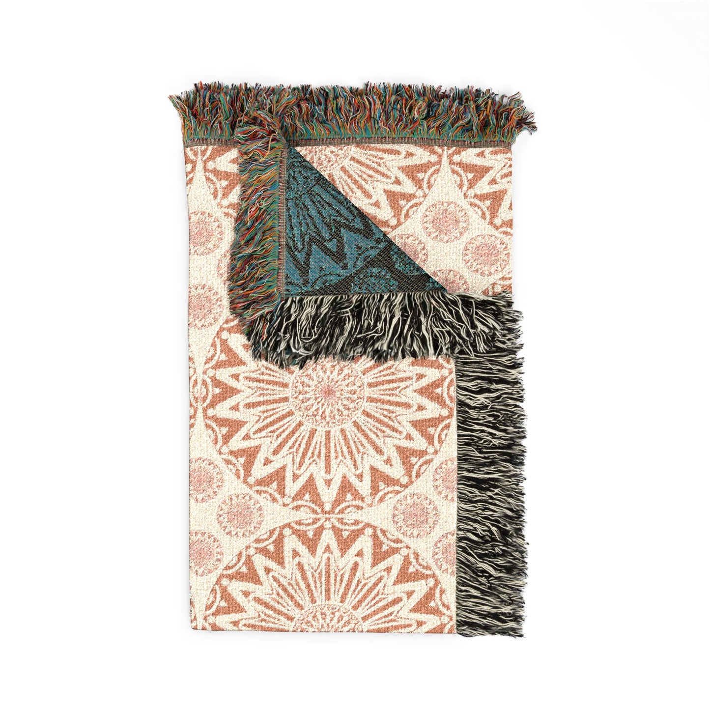 Folded Boho Mandala woven blanket showing the fringed edge and the teal reverse side