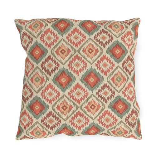 Boho outdoor pillow in cream with coral and sage green Aztec diamonds, front view