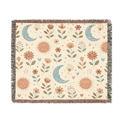 Boho Sun Moon woven blanket in cream with rust suns, blue crescent moons and florals, shown flat