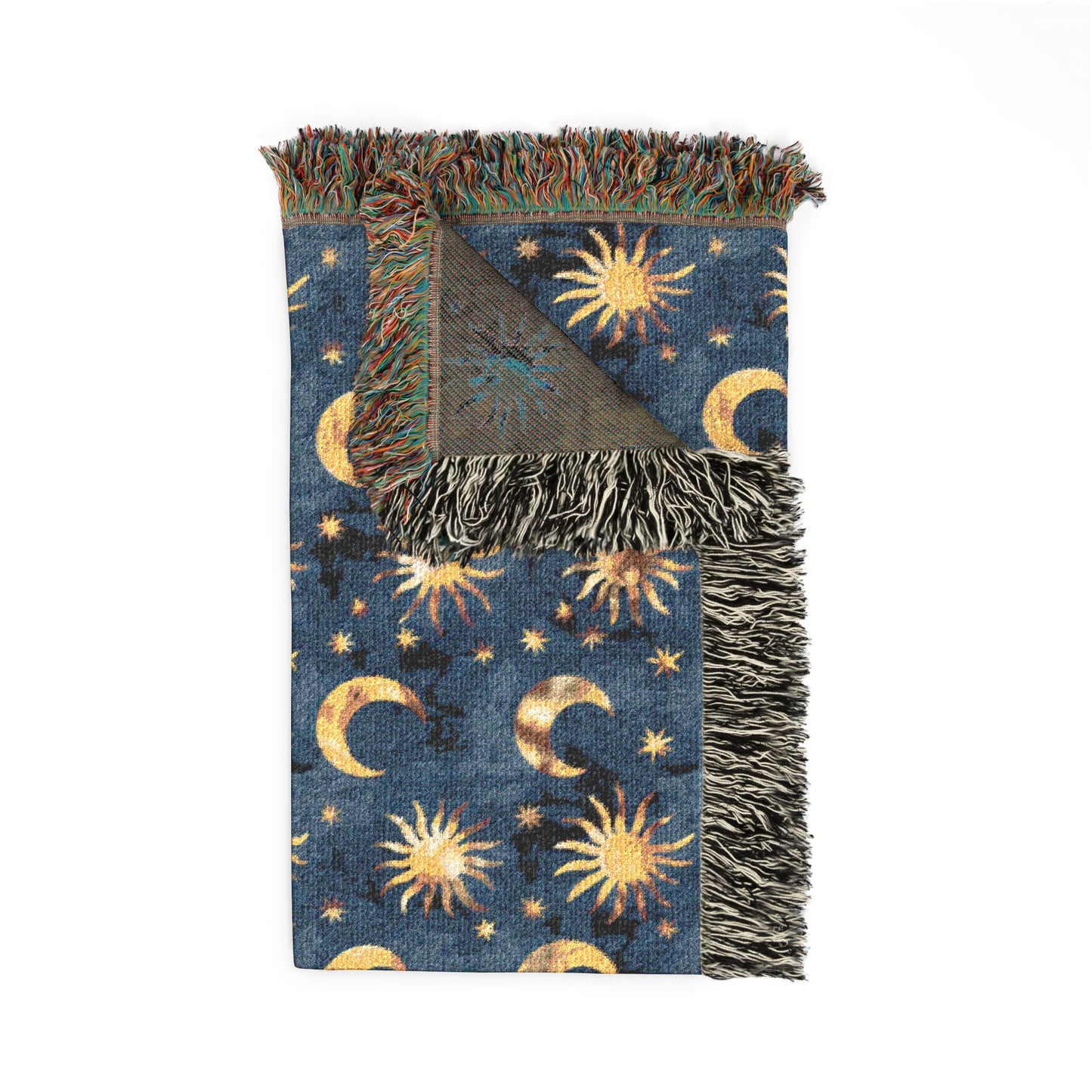 Folded Celestial Boho woven blanket showing the fringed edge and the reverse side