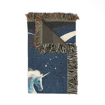 Folded corner detail of the celestial unicorn woven blanket showing the fringe edge