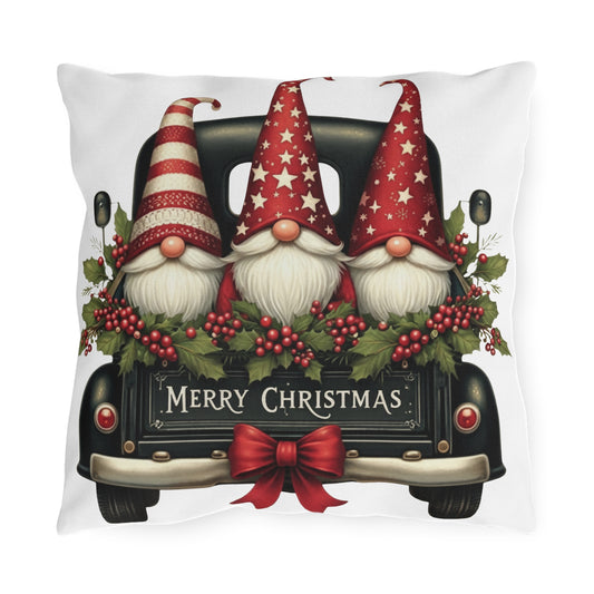 Christmas gnome truck outdoor pillow with three red-hatted gnomes in a dark green truck with a wreath and Merry Christmas lettering, front view
