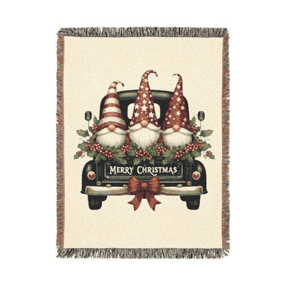 Christmas woven blanket featuring three gnomes riding in a vintage truck bed with holly, berries and a Merry Christmas message