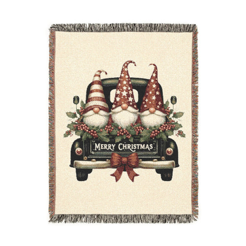 Christmas woven blanket featuring three gnomes riding in a vintage truck bed with holly, berries and a Merry Christmas message