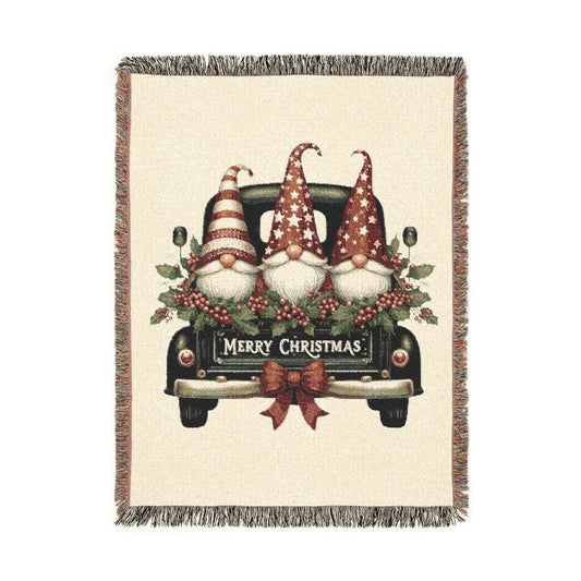 Christmas woven blanket featuring three gnomes riding in a vintage truck bed with holly, berries and a Merry Christmas message