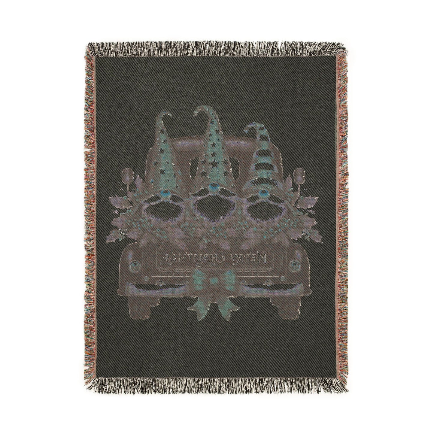 Christmas woven blanket featuring three gnomes riding in a vintage truck bed with holly, berries and a Merry Christmas message