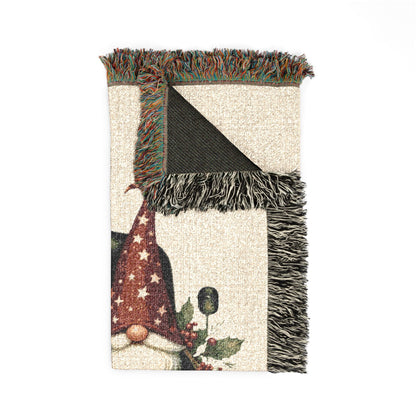 Christmas woven blanket featuring three gnomes riding in a vintage truck bed with holly, berries and a Merry Christmas message