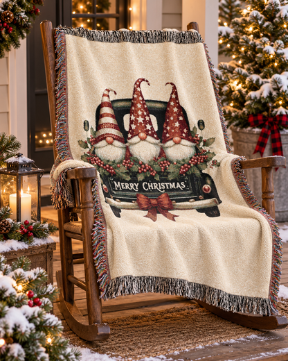 Christmas woven blanket featuring three gnomes riding in a vintage truck bed with holly, berries and a Merry Christmas message