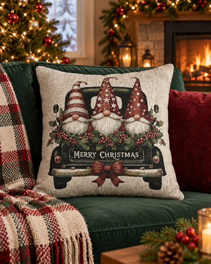 Christmas woven pillow featuring three gnomes in a vintage truck, styled on an armchair with a plaid throw blanket by the fireplace