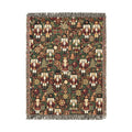 Christmas woven blanket with nutcrackers, gifts and ornaments on a deep green ground, shown flat