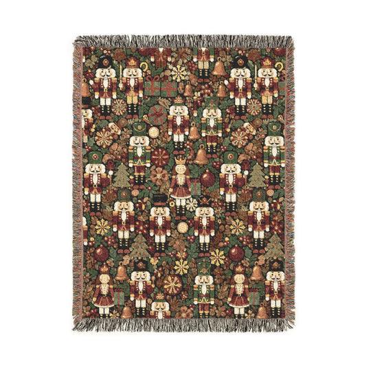 Christmas woven blanket with nutcrackers, gifts and ornaments on a deep green ground, shown flat