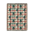 Christmas tree plaid woven blanket featuring dark green tree motifs on a rust and cream buffalo-check pattern