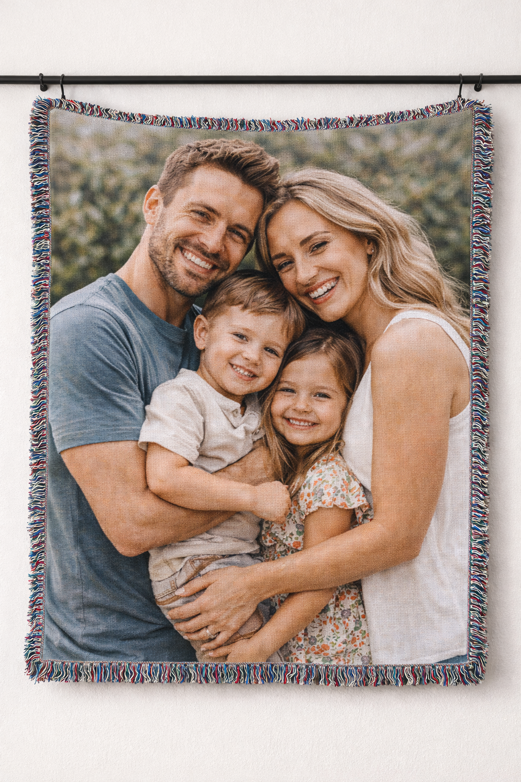 Custom photo woven blanket with a family photo of a couple and two children, shown hanging