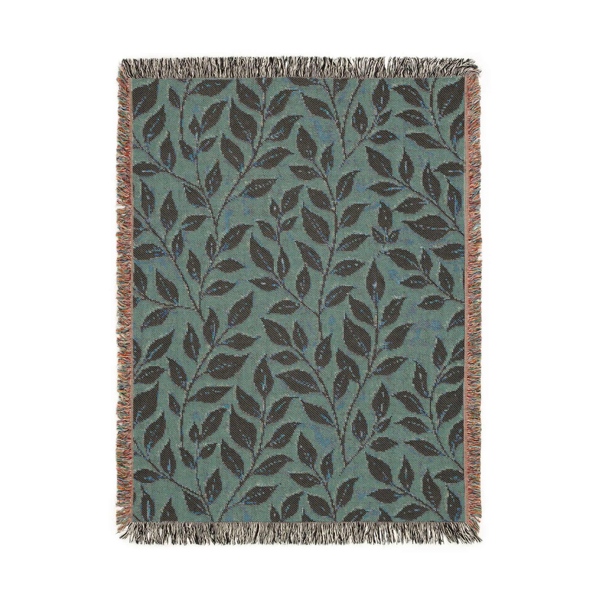 Reverse side of the woven blanket showing the same leaf pattern in sage teal