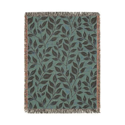 Reverse side of the woven blanket showing the same leaf pattern in sage teal