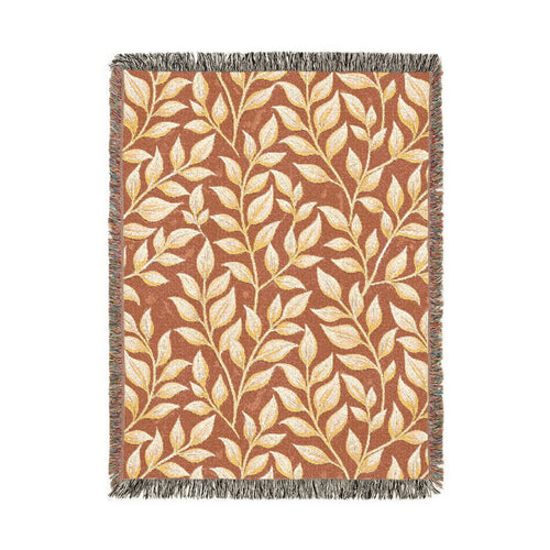Fall woven blanket in terracotta with cream and gold leaves, shown flat