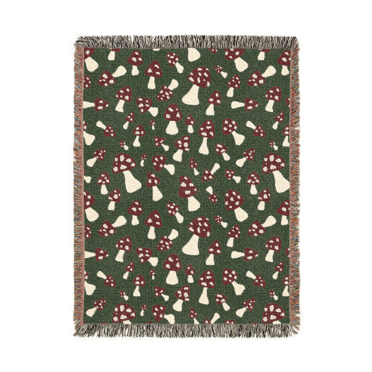 Fall woven blanket with red and cream toadstools on a deep forest green ground, shown flat