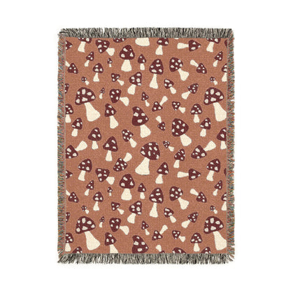 Fall woven blanket with cream and rust toadstools on a warm terracotta ground, shown flat