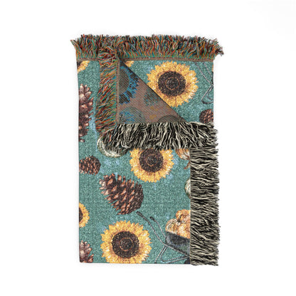 Folded Sunflower Teal woven blanket showing the fringed edge and the brown reverse side