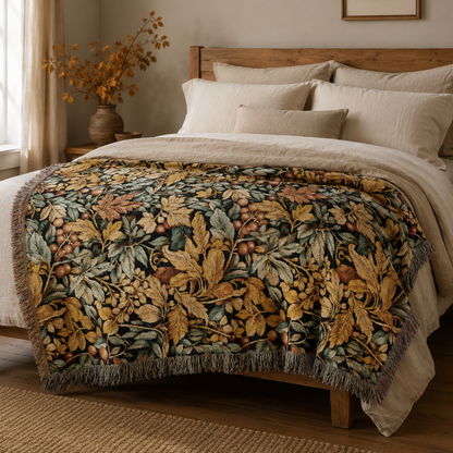 William Morris berry and leaf woven blanket spread across a made bed with cream pillows