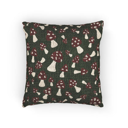 Fall woven pillow with red toadstools and cream spots on deep forest green