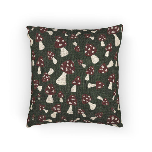 Fall woven pillow with red toadstools and cream spots on deep forest green