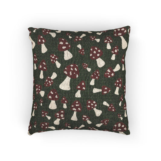 Fall woven pillow with red toadstools and cream spots on deep forest green