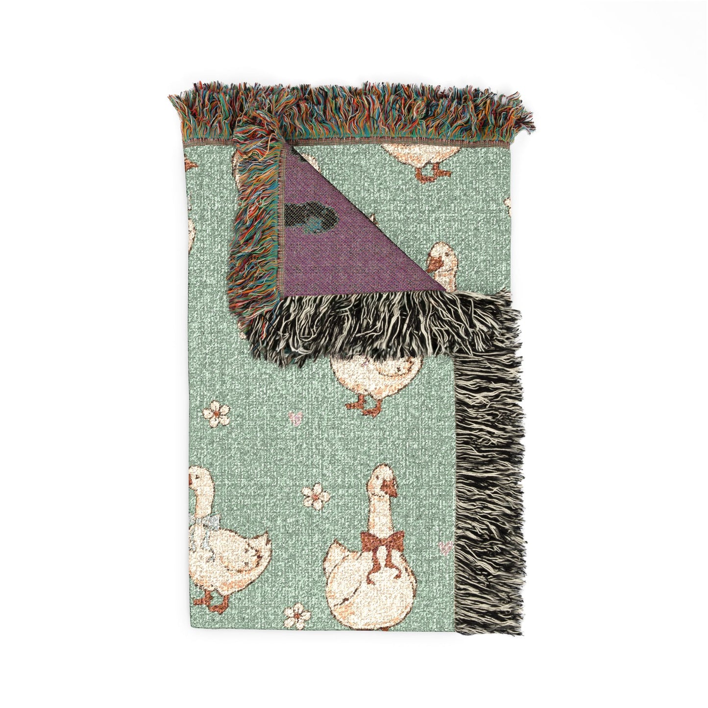 Folded goose woven blanket showing the fringed edge and the plum reverse side