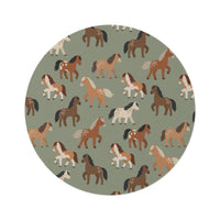 Round nursery rug with chestnut, rust and cream horses on sage green, shown flat