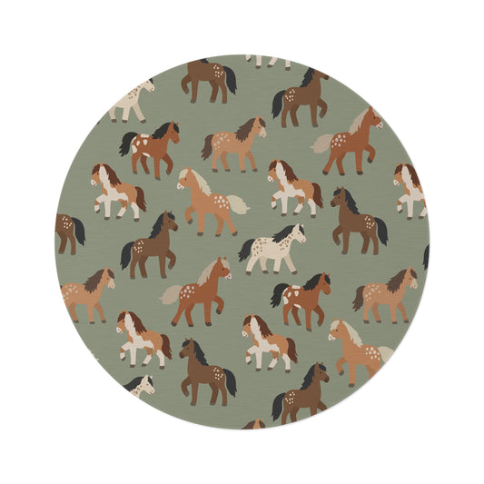Round nursery rug with chestnut, rust and cream horses on sage green, shown flat
