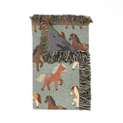 Folded horse woven blanket showing the fringed edge and the mauve reverse side