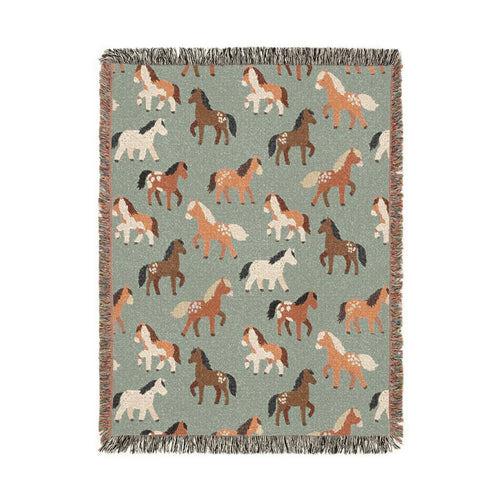 Sage green woven blanket with chestnut, rust and cream horses walking across it, shown flat