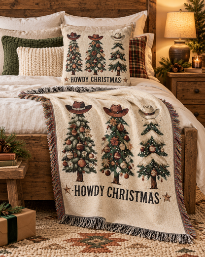 Howdy Christmas woven blanket and matching cowboy Christmas pillow on a bed
