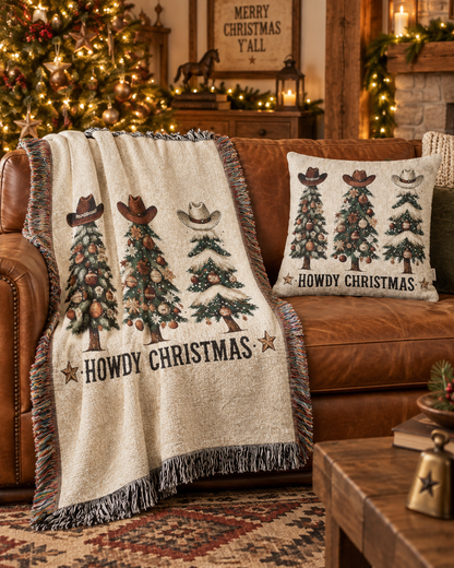 Howdy Christmas woven blanket and pillow on a leather sofa in a festive living room