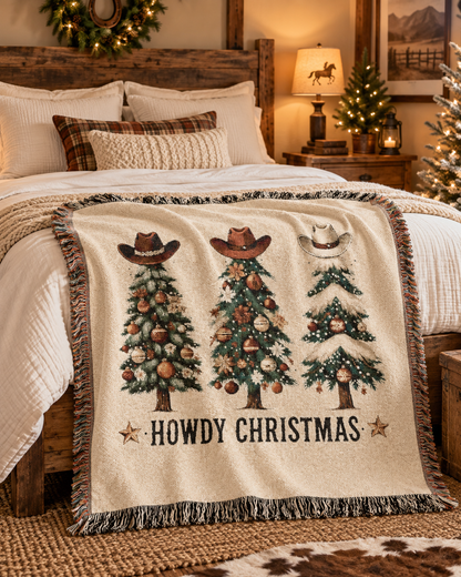 Howdy Christmas woven blanket layered across a bed in a cozy Christmas bedroom