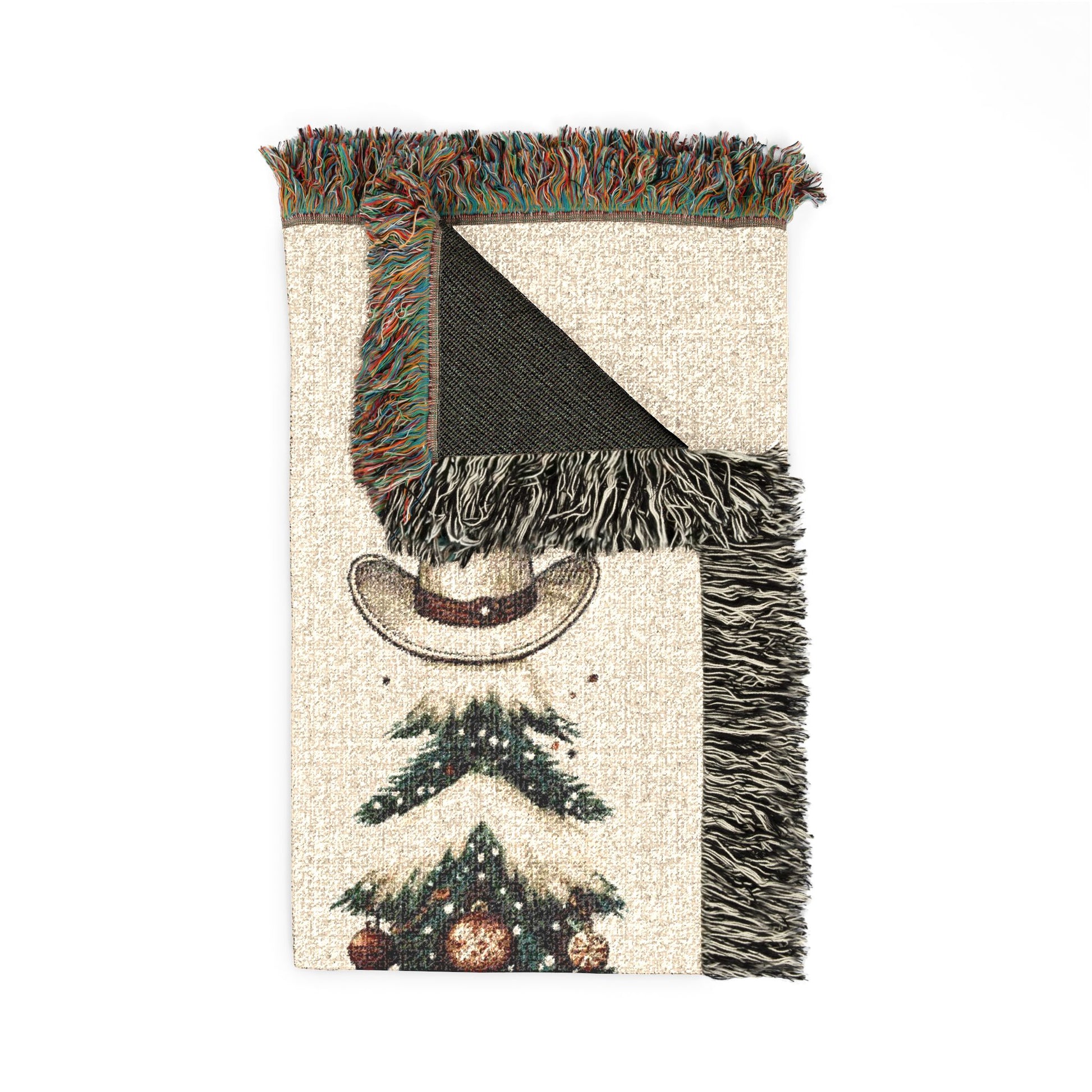 Close-up of the woven texture and fringed edge of the Howdy Christmas blanket