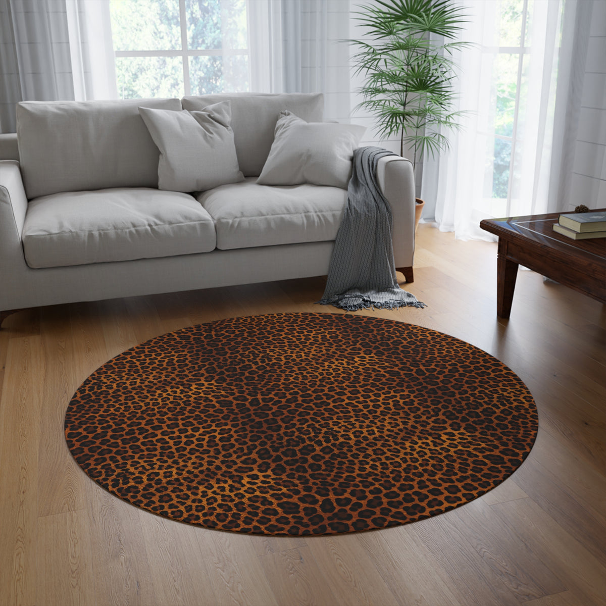 Leopard round rug on a wooden floor in front of a grey sofa