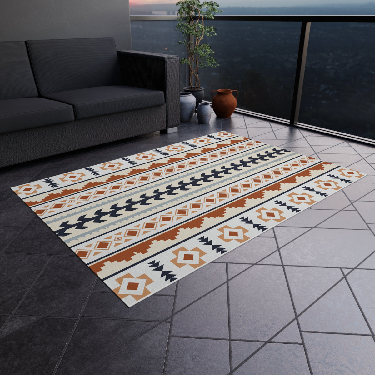 Mexican Boho outdoor rug on a grey tiled terrace next to an outdoor sofa
